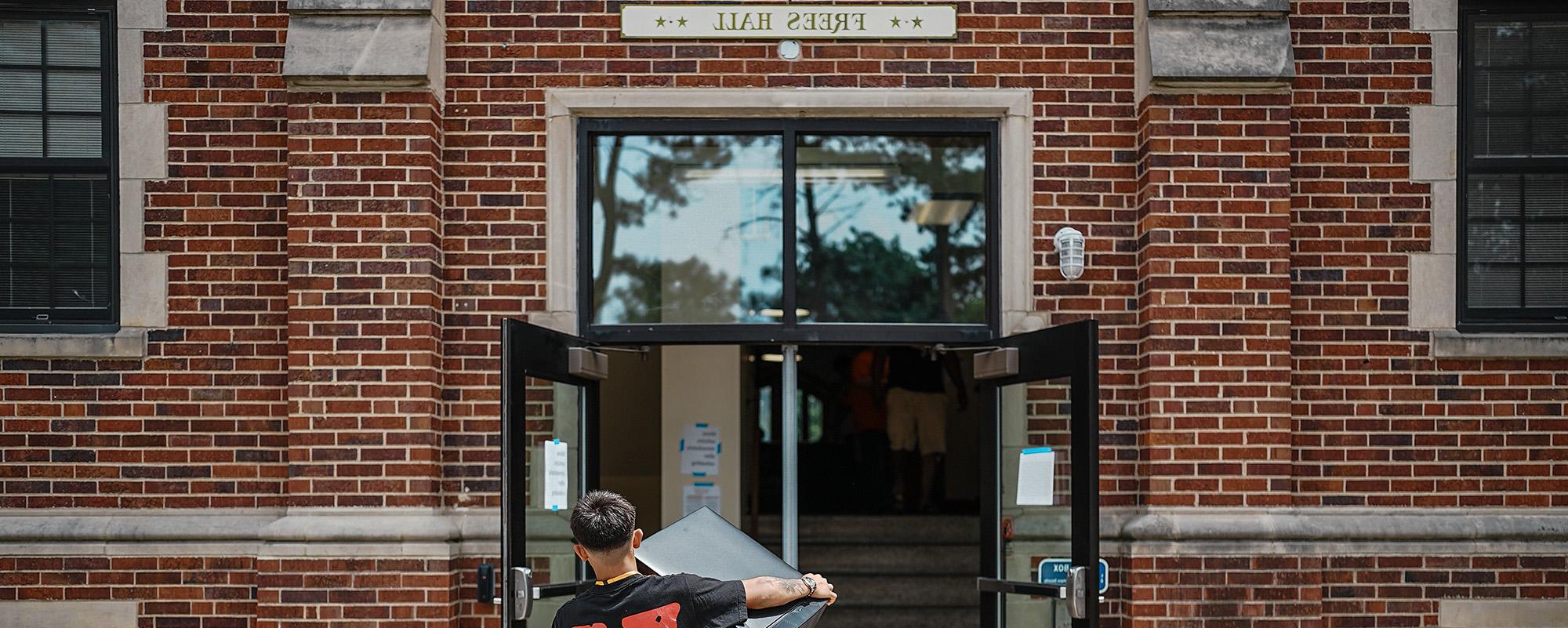 A student moving into Fees Hall